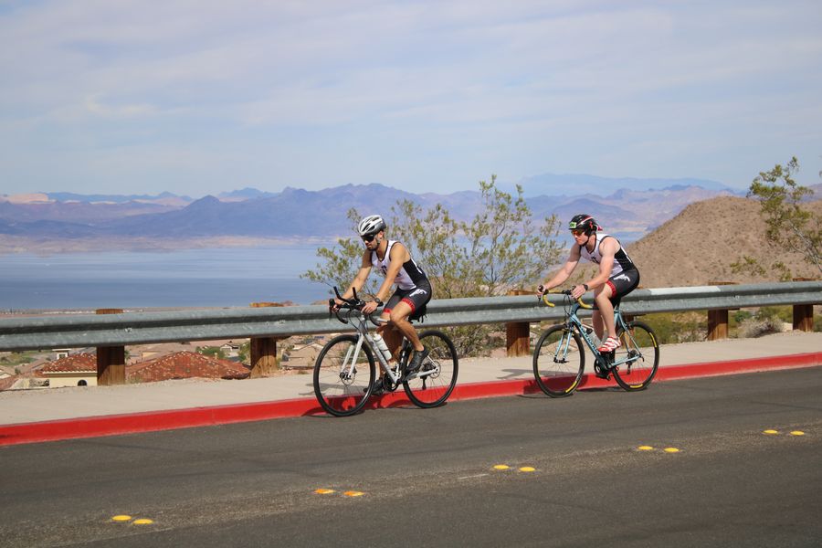 Colin and Philip biking up a hill at the Pumpkinman Triathlon